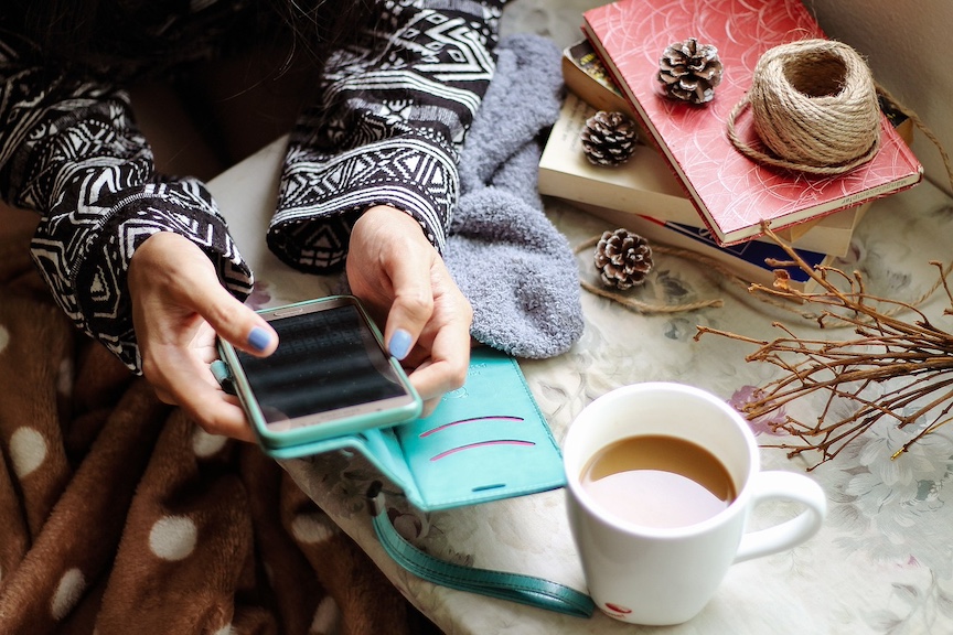 woman on her phone. connecting with a fertility community and finding a support in prenatal care.