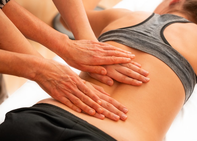 Hands massaging a spine. Fertility chiropractor Brookfield