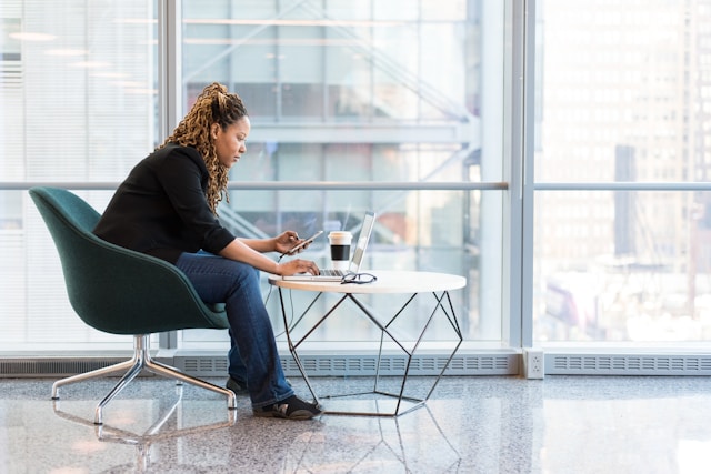 A woman with poor posture hunches over a computer. Brookfield chiropractor, spine health, mind-body connection. 