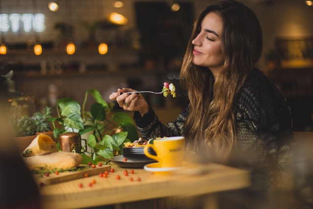 A woman enjoying a healthy salad. Nutritious food helps promote fertility