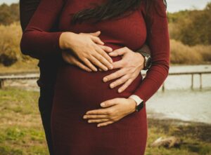 Woman and man holding pregnant belly